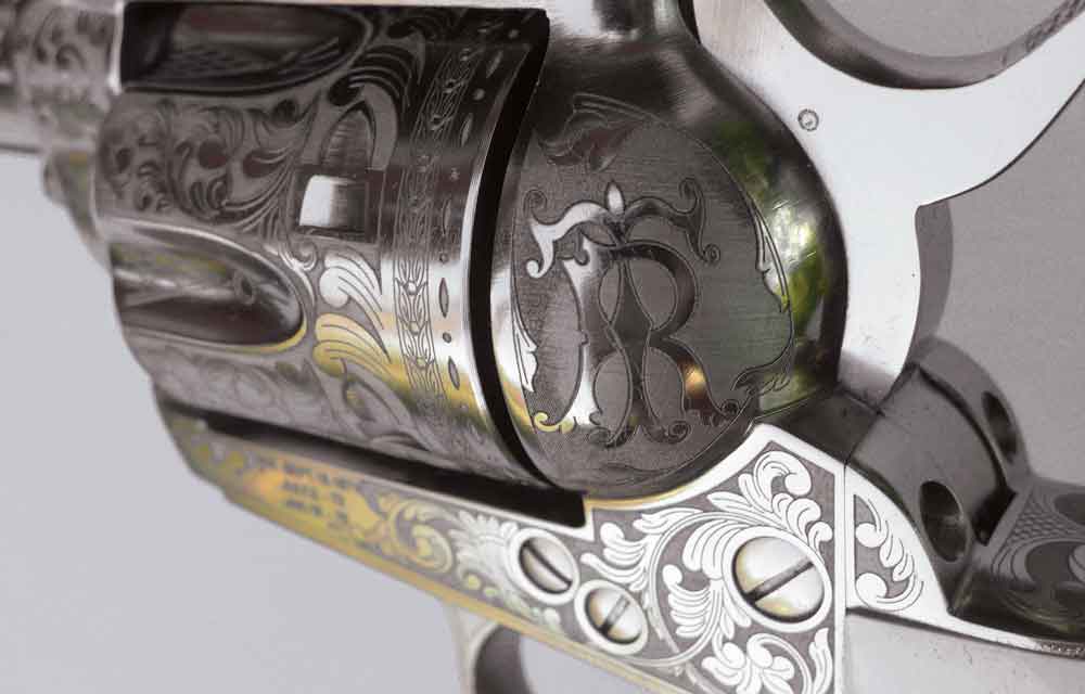 Cimarron Teddy Roosevelt Commemorative model — nickeled, mock ivory grips and deeply etch engraved all over. The “T.R.” initials are clearly seen engraved on this Teddy Roosevelt Commemorative revolver.
