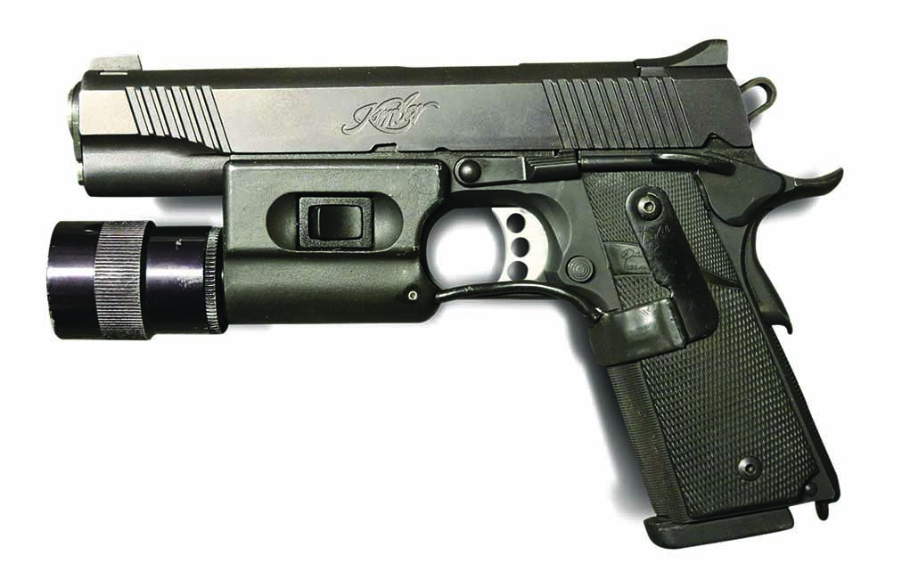 A period-correct LAPD SWAT pistol from the early 2000s. Before that, no Kimber. After that, a different Surefire light.
