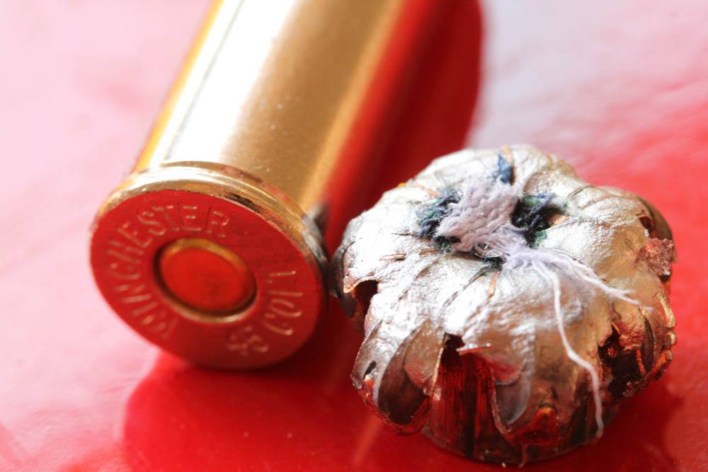The .45 has a hollow point so big you can see the results in this .45 Colt bullet. That’s a plug of cloth from the heavy cloth barrier test, in the open petals of the PDX1 bullet. It cut the cloth out, still expanded, and tracked so straight the cloth stayed in place.