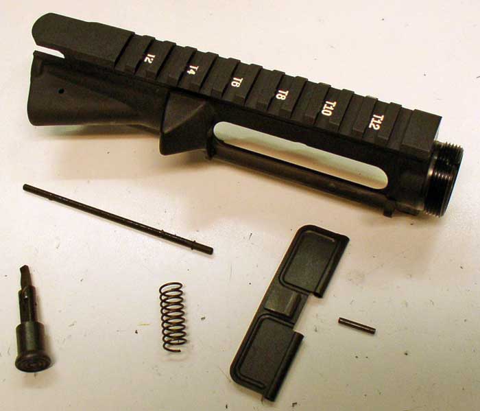 A stripped upper needs these parts, the completely useless forward assist assembly with spring and pin, and ejection port cover with spring, pin, and clip. The handy white T-lettering helps you to remember where you mounted the scope, after you took it off to clean the rifle.
