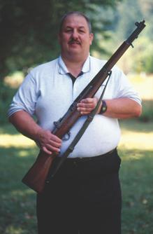 The author in younger days holding his late father's National Match M-1 rifle bought in 1960 at Camp Perry from the DCM.