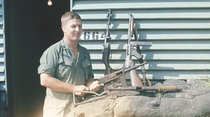 A much younger and slimmer author in Vietnam displaying some captured submachine guns. The author credits his CMP training and experiences with interesting him in military service and, once he was on active duty, helping him do well. The weapons are a French 9mm MAT 49, a Chinese copy of the Soviet 7.622?5mm PPSh41, an M-1 Thompson, and a British 9mm Sten Mk IIS with integral noise suppressor. 