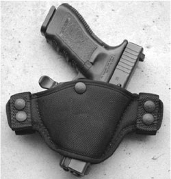 A good choice for open carry or concealed, this Bianchi Evader requires middle finger of drawing hand to hit a paddle to unlock this Glock 22.