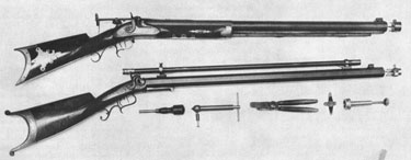 Top - This 19-lb. percussion rifle, shown with false muzzle removed, is signed J. Harding, Lowell, Mass. Cast Steel on the barrel. Nothing is known of this maker so far, yet this is too well made to have been an amateur's effort. The 32 1/2" octagon and 16-sided barrel is 50 caliber. All furniture except fore-end tip is German silver. This 20-lb. rifle carries an oval gold medallion inscribed Presented by the Helvetia Rifle Club of N.Y. to the Third Union Shooting Festival, New York, July 1868. At that time it was probably 45 caliber or larger, yet the barrel is signed George C. Schoyen, Denver, Colo., and the caliber is now 32. The mould and other tools are typically 32-40 cartridge style. The name on the lockplate is E. Phillips, N.Y., presumably the original maker. Emil Berger is engraved on the buttplate, possibly the man who won this rifle in 1868.