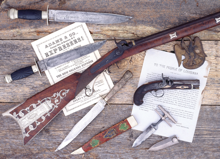 Historical, silver-mounted percussion half-stock “Kentucky” rifle made c. 1850s for Major Robert Anderson, Union hero of the Civil War, by Daniel Searles, of Baton Rouge, Louisiana.  Searles is best known for the knives he made for Rezin (and Jim) Bowie. The sideplate is also richly engraved and inscribed with Anderson’s name.  Illustrated here with a Henry Deringer percussion belt-size pistol with barrel markings indicating it was specifically made for Hyde & Goodrich, New Orleans, merchants and agents for Henry Deringer and importers of weapons.  Illustrated with three Bowie knives and a gambler’s push-dagger, all with New Orleans maker or importer markings. 