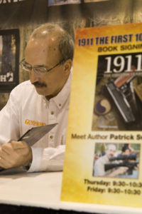 Patrick Sweeney at the Gun Digest Booth during SHOT Show 2011, signing 1911: The First 100 Years