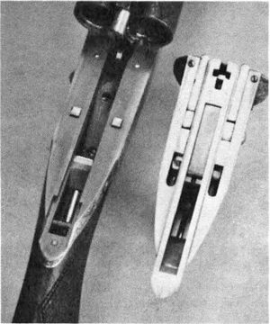 The bright squares on the receiver are, in effect, the sears of the Darne action. At right is the actual receiver turned upside down.