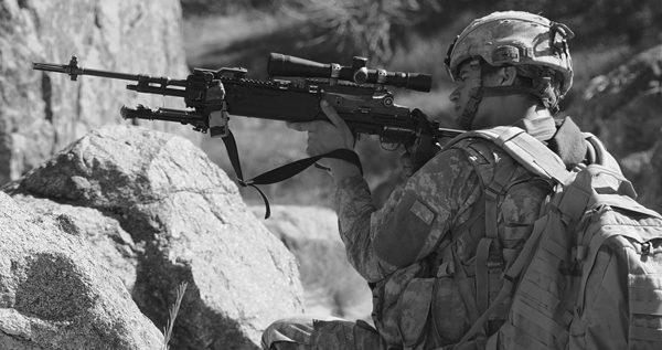 In the mountains, where you might need range, a .308 rifle can be quite useful, Here Spc Rockwell scans the ridgeline. DoD photo by Spc. Eric Cabral, U.S. Army.