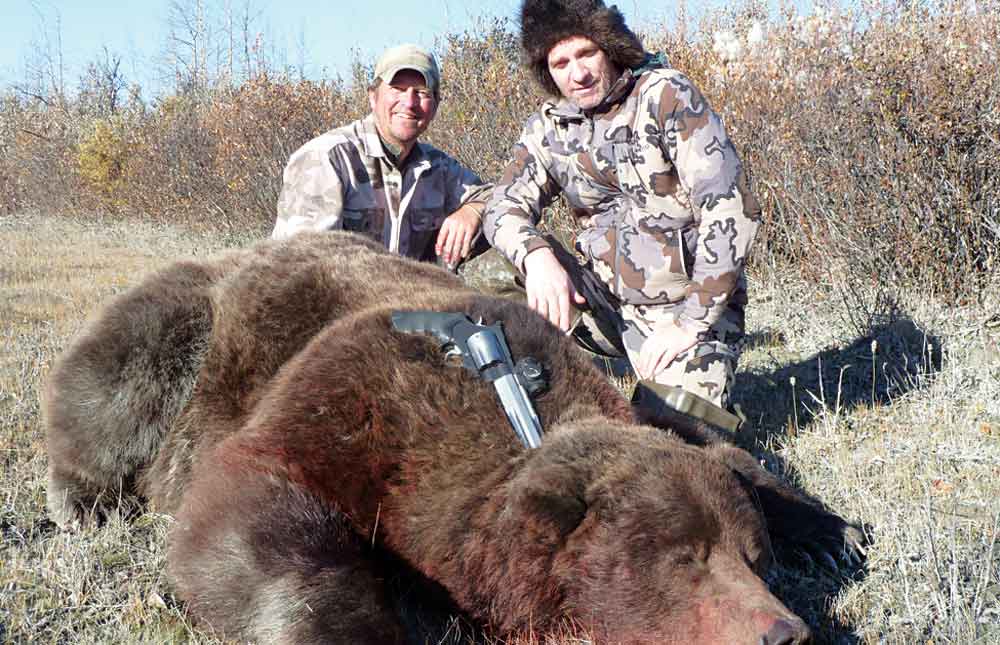 Guide Don Martin with Ernest Holloway and the grizzly bear that charged them. 