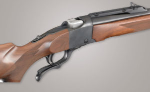 Features shown here include the thumb safety, and the quarter rib with integral scope bases and a folding rear sight.