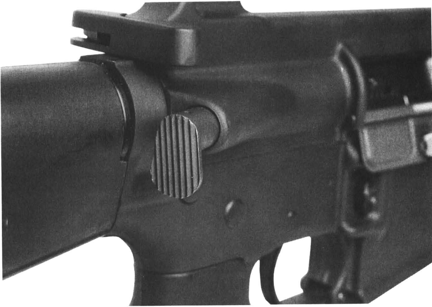 The forward assist bolt closure mechanism. The M16A1 (shown) had the “tear drop” style while the new M16A2 has a round button style.