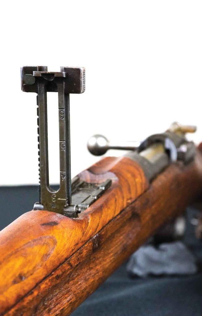 The m/1896, like other military rifles, used a simple but effective iron-sighted system. Here, you can see the rear leaf sight with a V-shaped notch. Soldiers weren’t handicapped without modern day optics with this sighting system, which, when folded down, graduated from 300 to 600 meters. When the sight is flipped up, it is graduated from 700 to 2,000 meters.