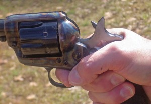The old gunfighter’s secret grip is necessary to make the Colt Single Action point its best. The palm of the hand is against the backstrap, not beside it. The grip is as high as possible with the hammer spur digging into the back of the hand. The flat Colt logo panels at the top of the grip are squeezed between the thumb and the ball of the hand at the base of the trigger finger, both of which are angled downward. The trigger is hooked by the first joint of the trigger finger, while the tip of the trigger touches the tip of the thumb. Squeezing the flat logo panels aligns the gun with whatever you are pointing at, and squeezing the trigger is converted into a steadying force instead of a disruptive force – enabling the shooter to get the maximum accuracy from the gun and cartridge.