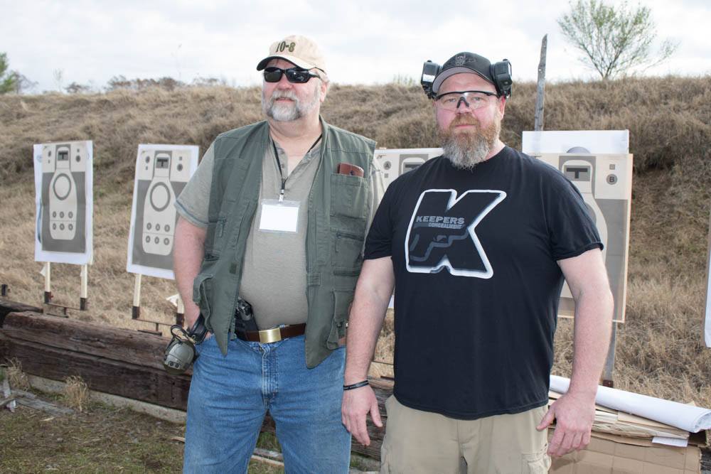 AIWB critic Marty Hayes, left, gives it a try with 1911 at a class with AIWB advocate Spencer Keepers, right. Both men are open-minded and can “disagree without being disagreeable.”
