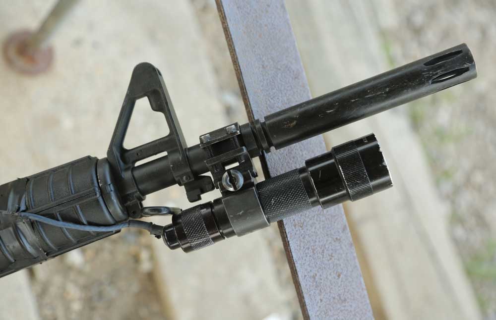 Mounting a light on an AR is simple, and it can even be brutally simple. In a pinch, a hose clamp gets the job done.