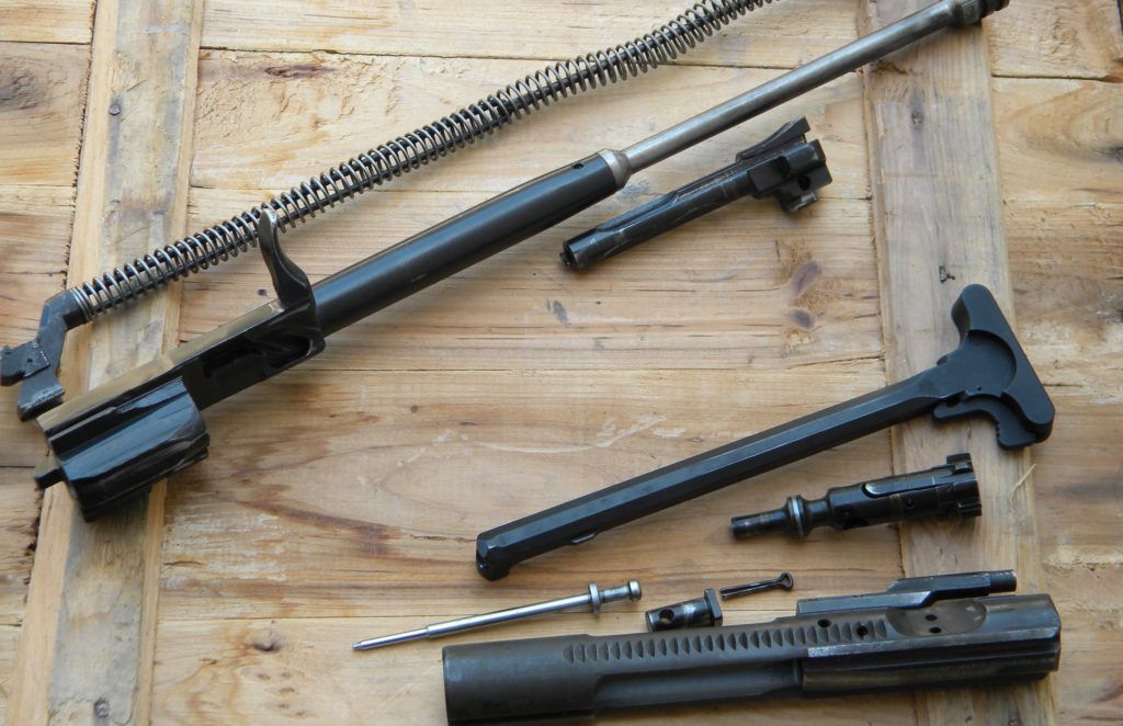 The AR is a little more complicated than the AK. Here you can see the bolt groups, with the AK components on top, which are not made to be taken apart. The AR allows you to change out things like the extractor or spring without special tools or knowledge.