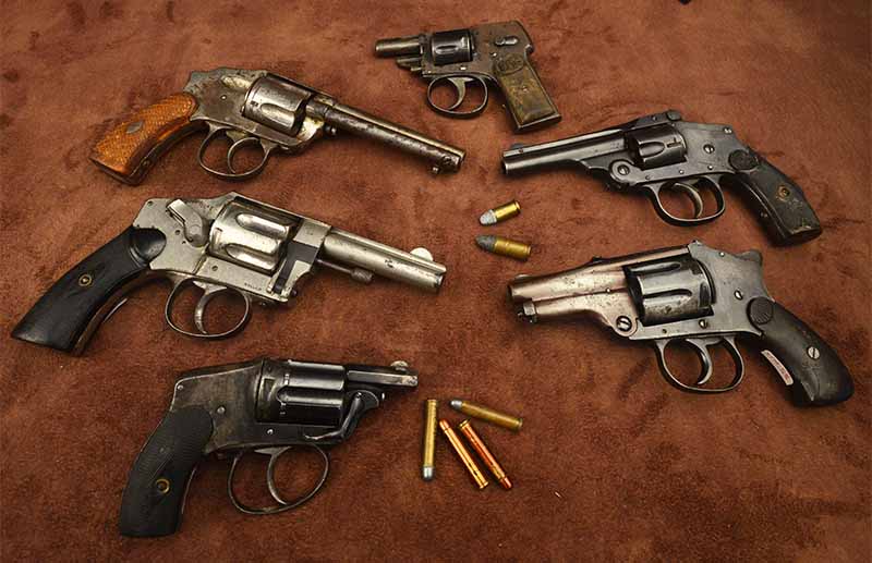 : European Velo-Dog and other hammerless revolvers, with .5.5 Velo-Dog cartridges compared to .32 and .38 S&W rounds. Stoney Roberts photo