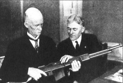 Inventor John M. Browning (left) and Frank Burton of Winchester with an early production BAR in 1918.