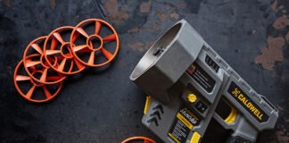 Caldwell ClayCopter Review: The Next Evolution Of Shotgun Fun A Caldwell ClayCopter Hand-Held Thrower next to its special clays on a black background.