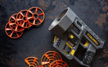 Caldwell ClayCopter Review: The Next Evolution Of Shotgun Fun A Caldwell ClayCopter Hand-Held Thrower next to its special clays on a black background.