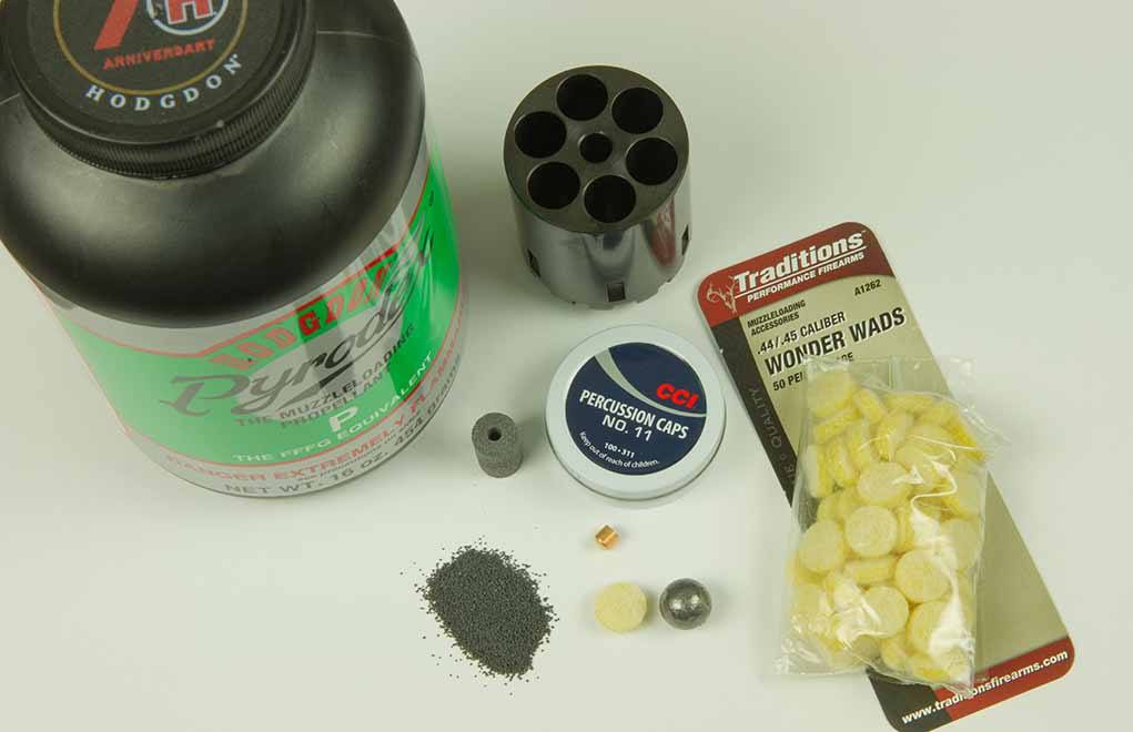 Cap-and-ball, also called blackpowder guns, must have components loaded into the charge holes or cylinder, one at a time. Included here is loose Pyrodex R propellant, a Pyrodex pellet, a percussion cap, a felt wad and a round lead ball.