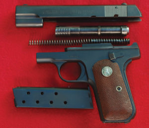The M-1903 shown here is disassembled into its component parts. The recoil spring (called by Colt as the “retractor spring”) has a guide rod and fits into holes in the frame and slide. The eight-round magazine has witness holes to show the number of rounds remaining in it. The gun is easily reassembled.
