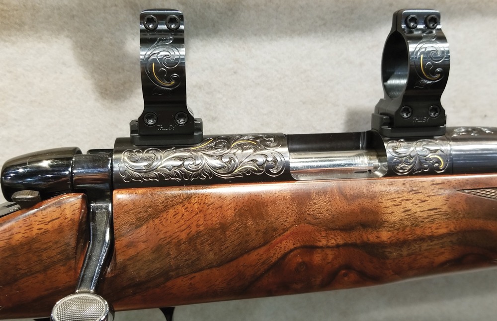 Engraving adds an unmistakable touch of class to any riﬂ e. Even the scope rings on this Remington custom rimﬁ re, which was on display at the SCI convention in Las Vegas, are engraved and feature gold inlays.