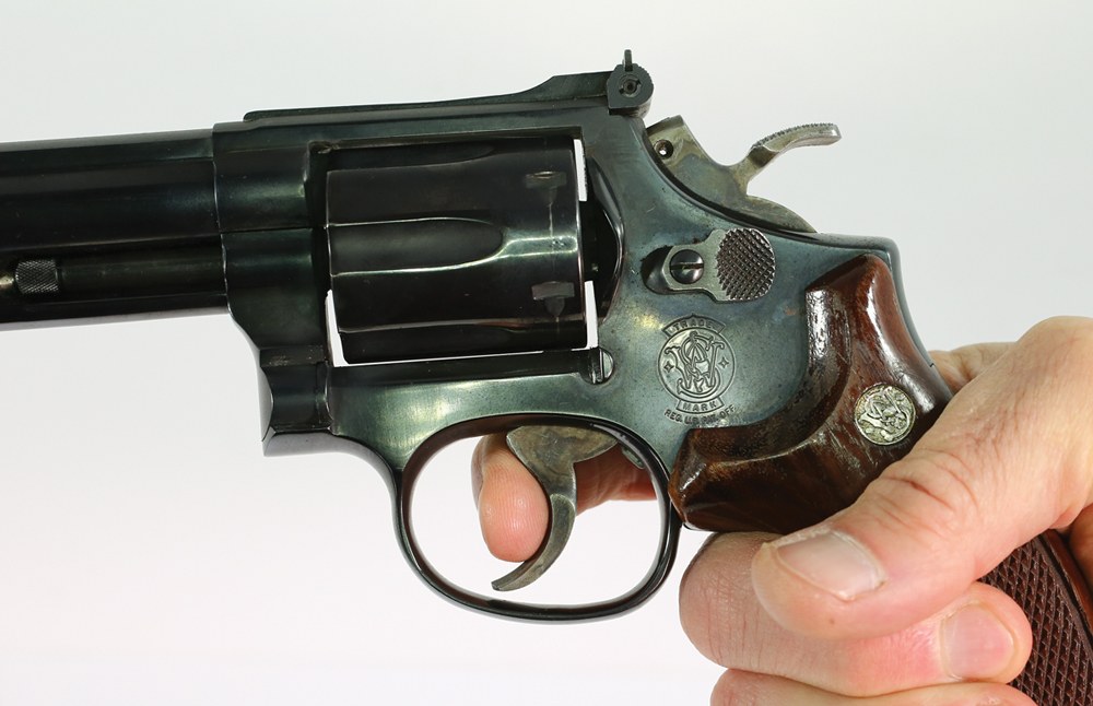 Do not grip the revolver with your hand directly behind the trigger. Get as high on the grips and frame as you can.