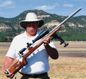 The author and his rifle with the NRA Whittington Center’s George Tubb range as backdrop.