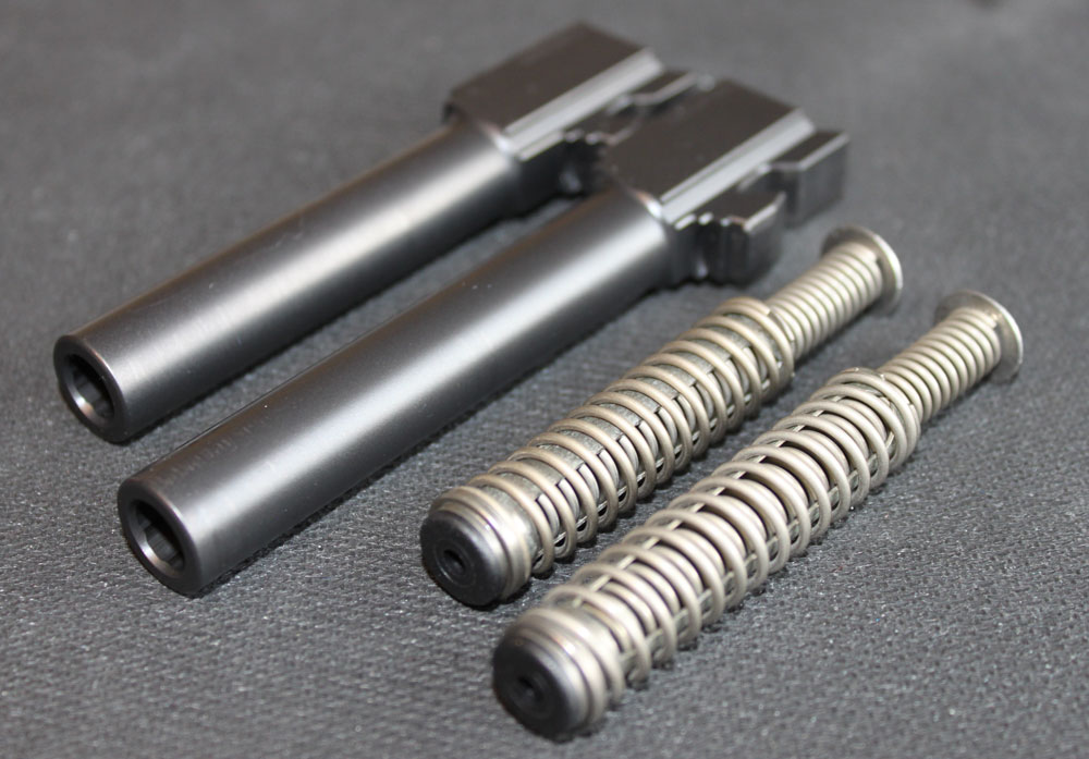 A G19 barrel and spring (the top barrel and the top spring) compared to a G17 barrel and spring.