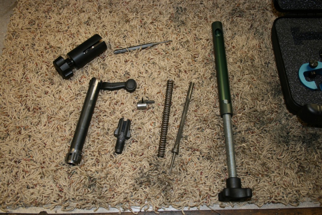 Disassembled bolt and tools.