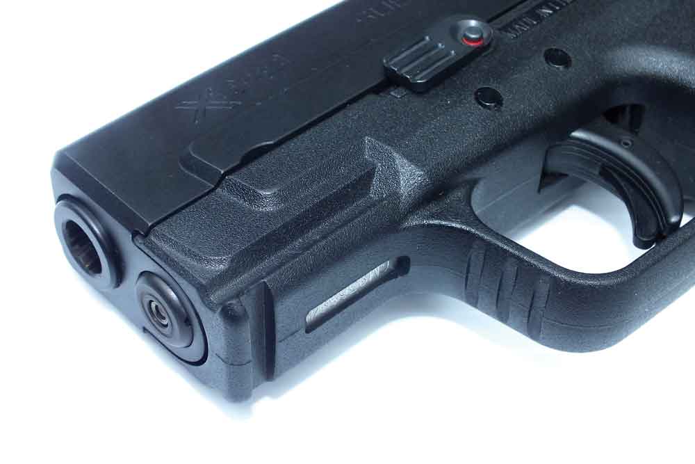 The Lasermax system solves the holster problem by putting the laser inside the pistol’s recoil spring guide rod. The manual activation switch is in the takedown lever. - laser sight 3