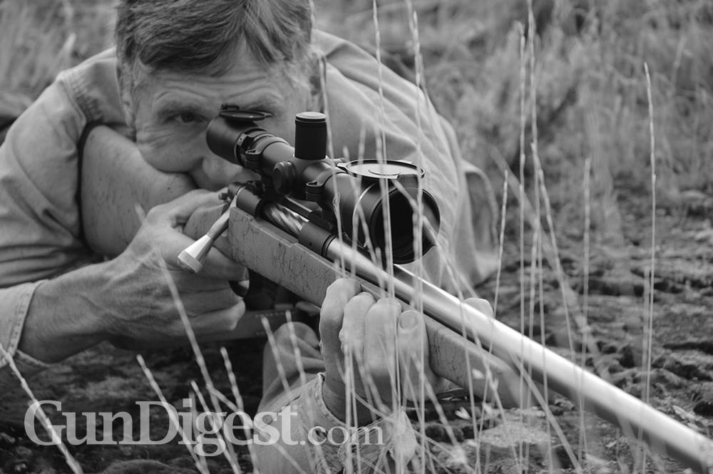Prone in prairie grass, Wayne steadies a heavy-barreled .33 wildcat on a Remington action. The 4.5-14X Leupold is standard GreyBull fare. It has given him saucer-sized groups at 780 yards.