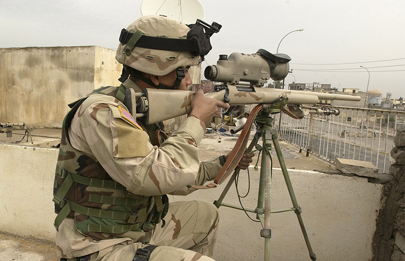 US Army Specialists armed with a 7.62mm M24 sniper rifle, equipped with an AN/PVS-10 Day+Night Vision Sniper Scope, scana for enemy activity at 4 West, an Iraqi Police station located in Mosul, Iraq, following an attack by insurgents. 