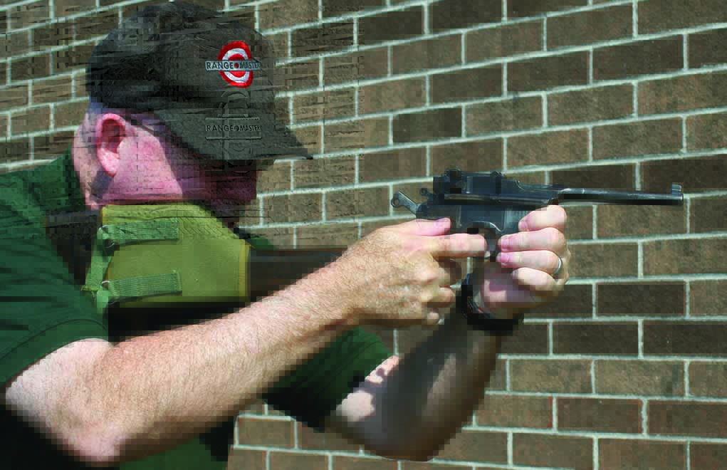 Master self-defense instructor Tom Givens demonstrates what may be the most efficient two-handed firing hold of the shoulder-stocked Mauser pistol.