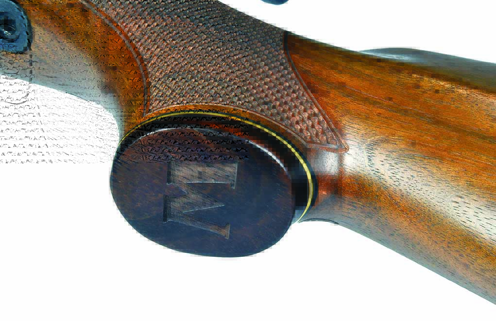 A rosewood grip cap, adorned with an “M,” is fitted to the bottom of the grip.