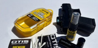 Gear Review: Otis Lens Cleaning Kit The contents of the Otis Lens Cleaning Kit spread out next to a Glock 26 on a white background.