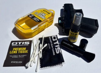 Gear Review: Otis Lens Cleaning Kit The contents of the Otis Lens Cleaning Kit spread out next to a Glock 26 on a white background.