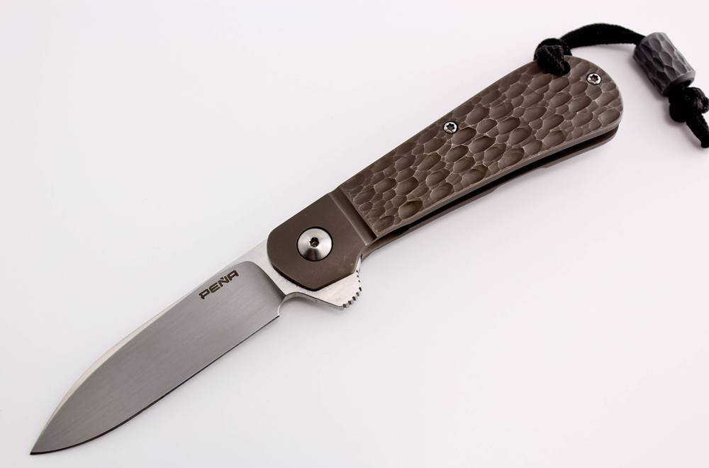 This Enrique Pena handmade “Zulu” frame-lock folder sports a 3-inch blade (an ideal size for an EDC knife) and jigged titanium handle scales.