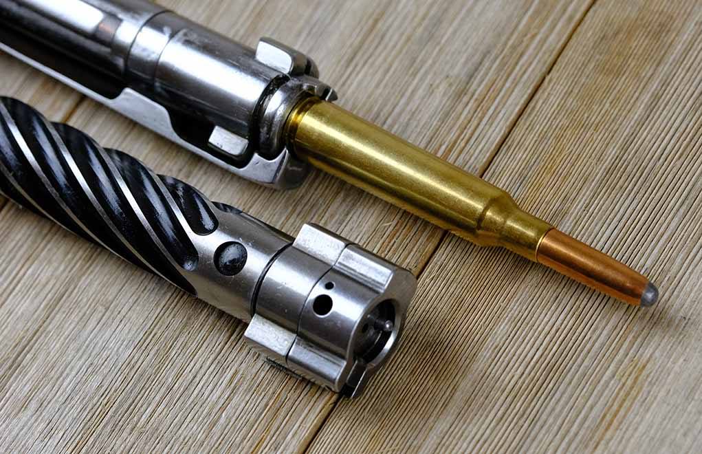 Here, the author shows the physical differences between a modern push-feed bolt, a Savage Model 14 short-action chambered for .300 Savage, and a Mauser K98 bolt, which is a controlled-round feed design.