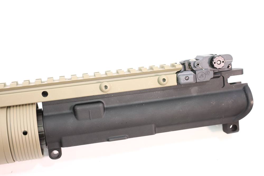 The top rail bolts to the upper receive by means of through bolts that pass along the notches in the upper receiver rail.