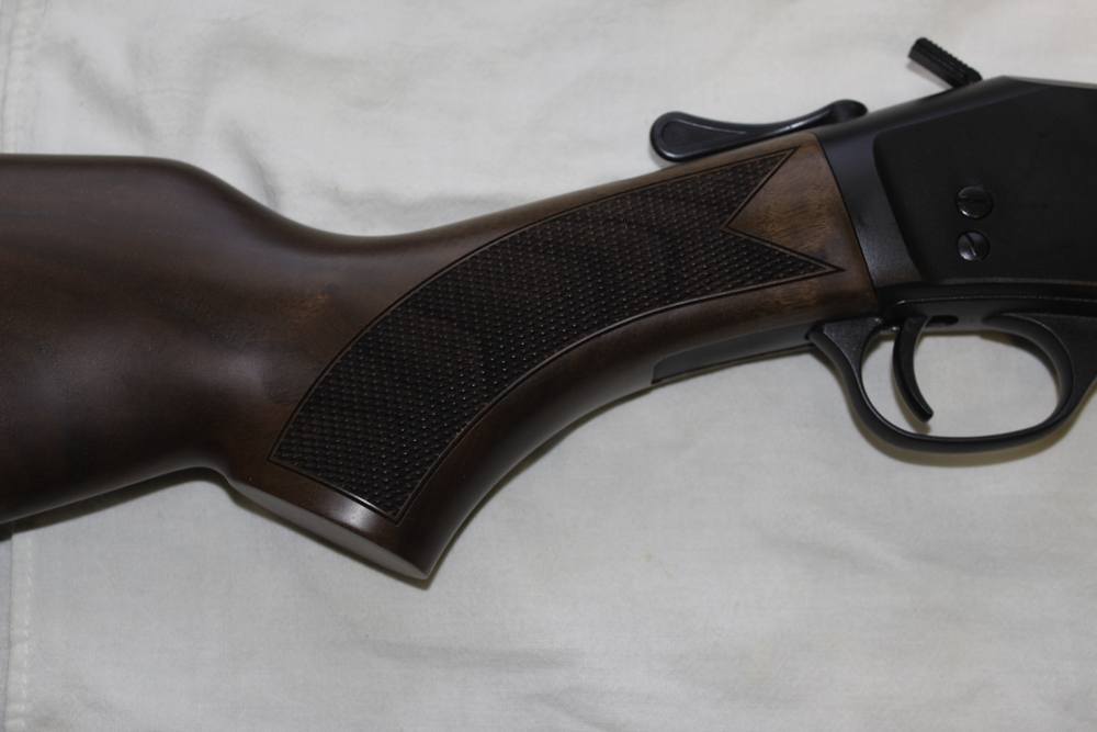 The black walnut stock is checkered to provide a more secure grip.