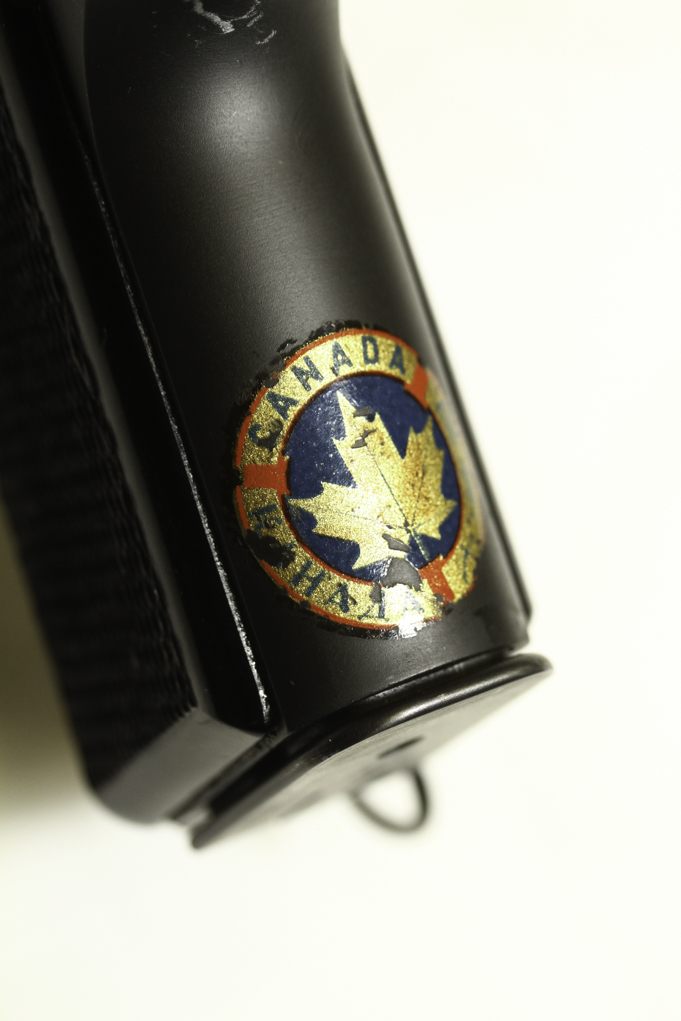 Collectors get excited over things like this. For a while, Canada used decals to mark property. To find a Browning Hi Power with the decal still more-or-less intact is wondrous.