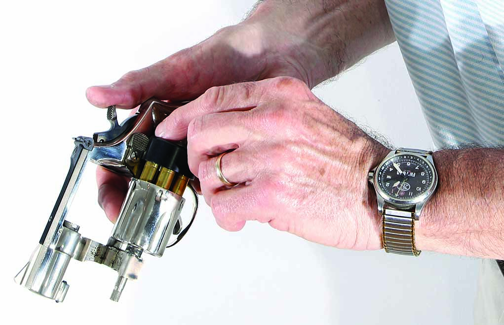 Here’s the speed load—competition style. With this method, you don’t let go of the revolver with your firing hand and you do the ejecting and loading with your other hand. Notice that the trigger finger keeps the cylinder from rotating when it comes time to turn the speedloader knob.