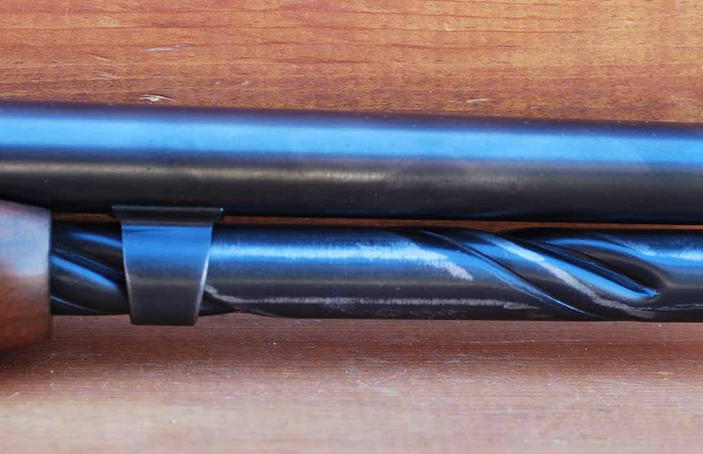 The M-141’s tubular magazine has spiral grooves to facilitate the use of spitzer bullets. It does not rotate, and it moves back with the slide when the action is worked.