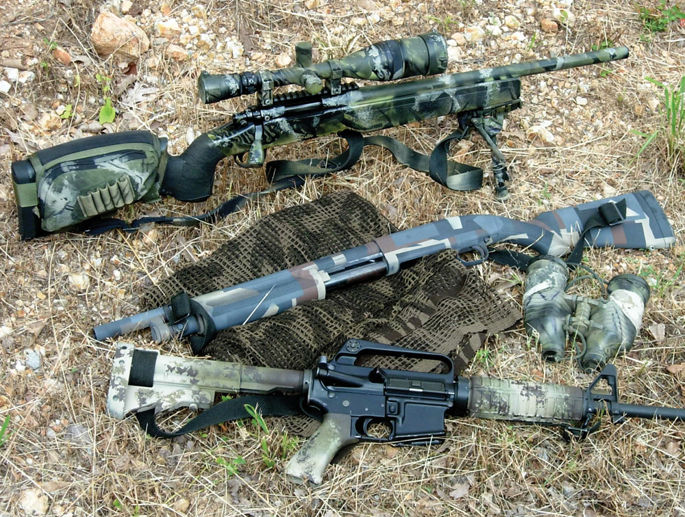  The finished products are pictured here. The AR was painted using the sponging technique and the shotgun was camouflaged for urban environments using the masking technique. Several of the different techniques were used on the bolt rifle.