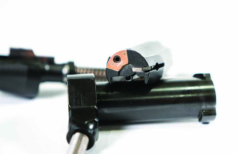 The money shot. The bolt face on the RimX shows the flush extractor held in place with a setscrew, the flat plunger and spring ejector (right) and the firing pin hole in the 6 o’clock position. 