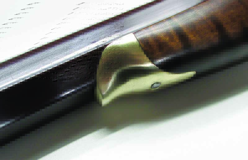 Preserving the fine wood, Pedersoli tips the fore with a brass nose. Note the curve to it, which is perfect for nestling into a set of shooting sticks.