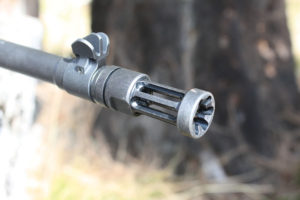 The 16.1-inch barrel wears a flash hider that comes off, making room for other barrel attachments. Notice the black blade front sight that is well protected. Author photo
