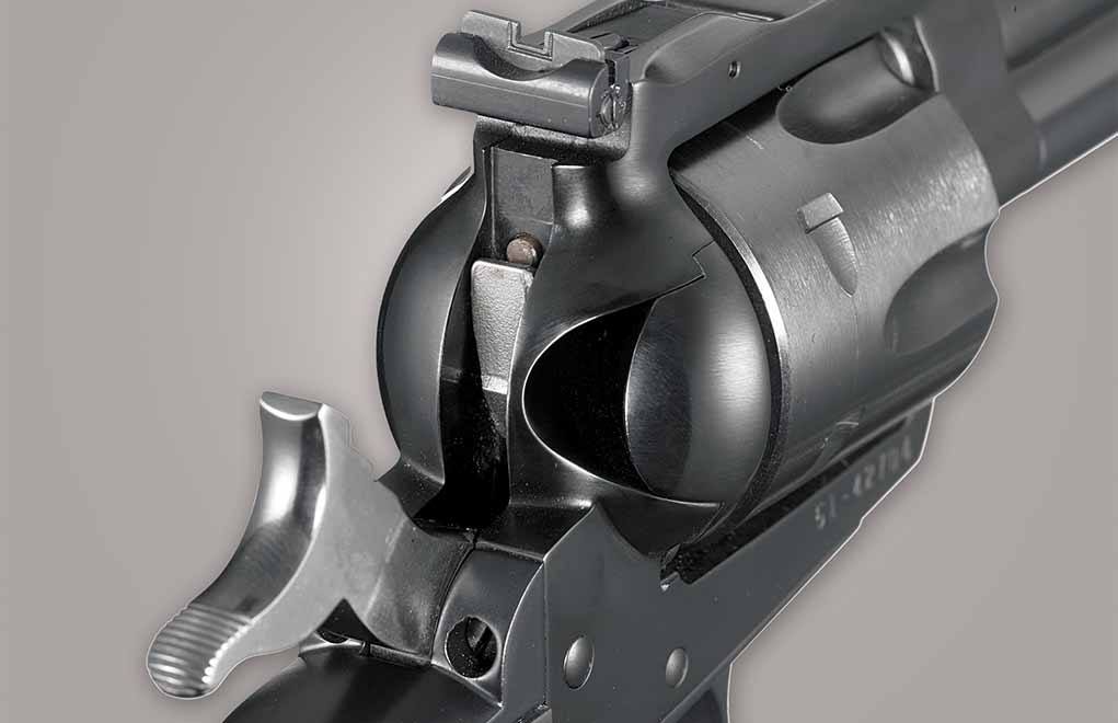 This picture of a New Model Single Six illustrates two important Ruger features — the contour-shaped loading gate, and the famous transfer bar firing system shown in the cocked position. When the trigger is pulled, the bar drops down to allow the hammer to hit the firing pin.